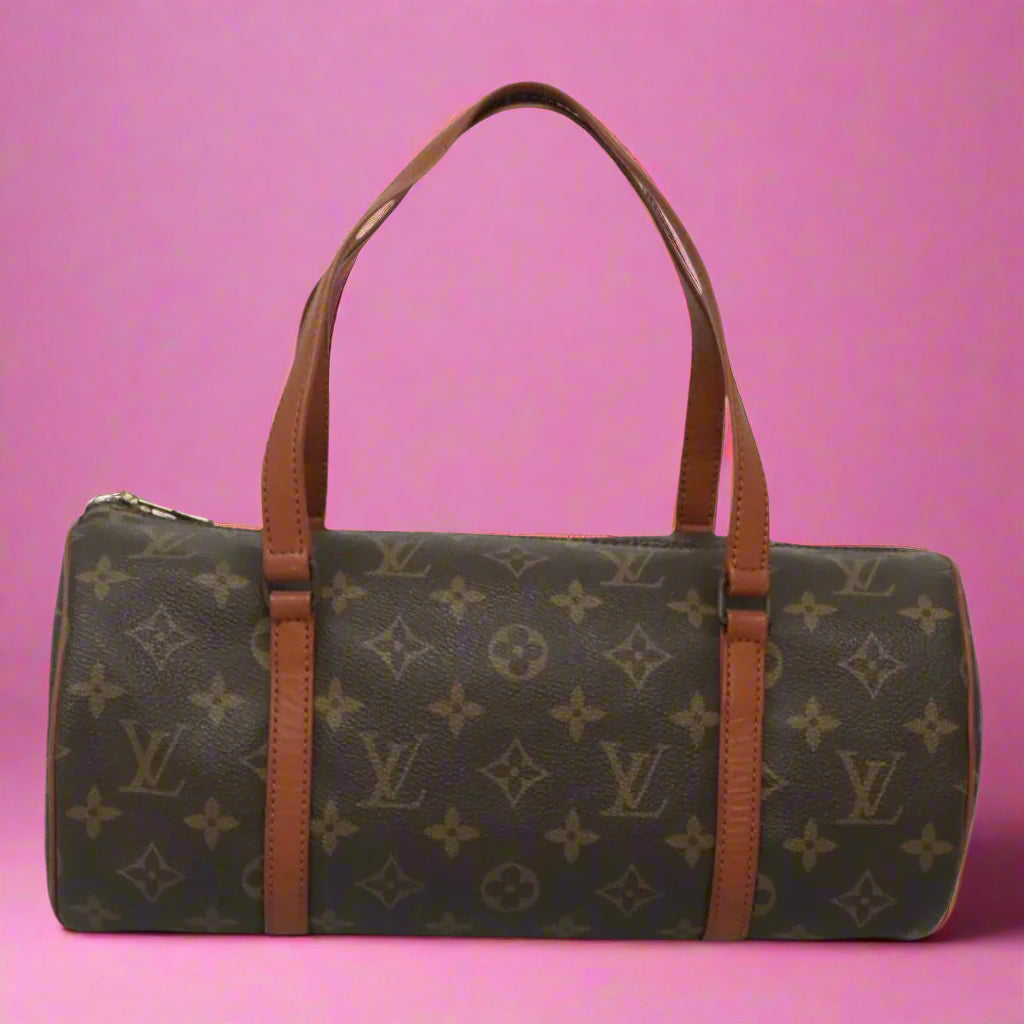 Designer handbag with monogram pattern on a white background
