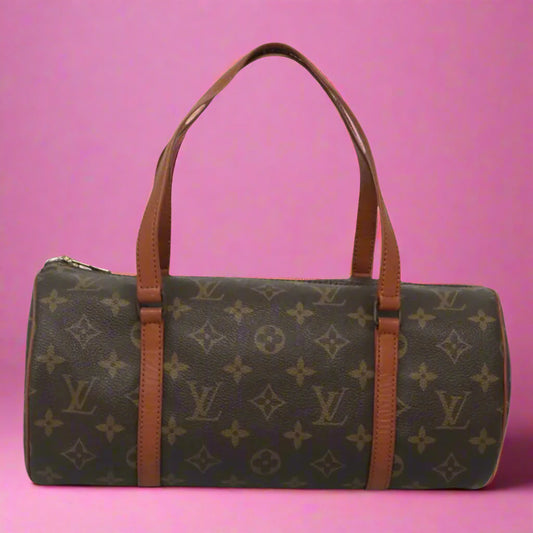 Designer handbag with monogram pattern on a white background