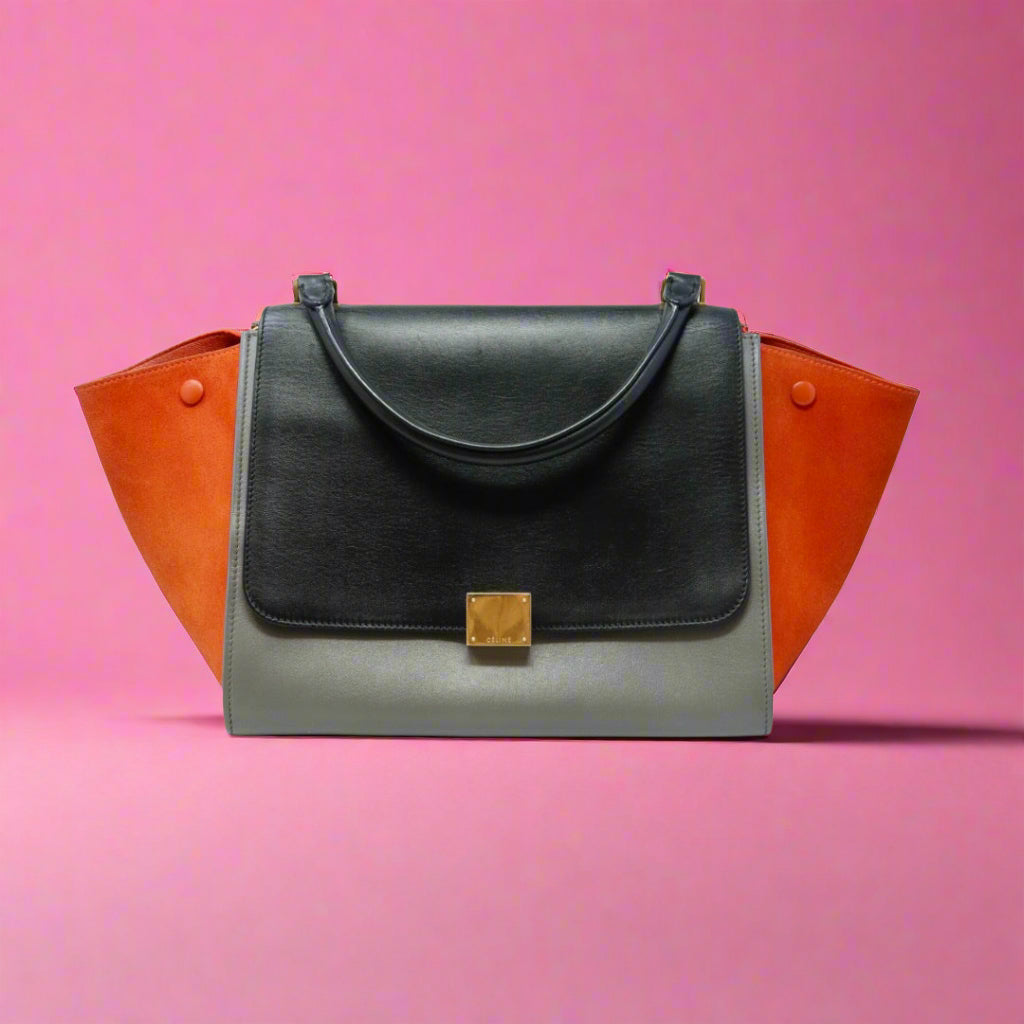 Black handbag with orange accents on a white background