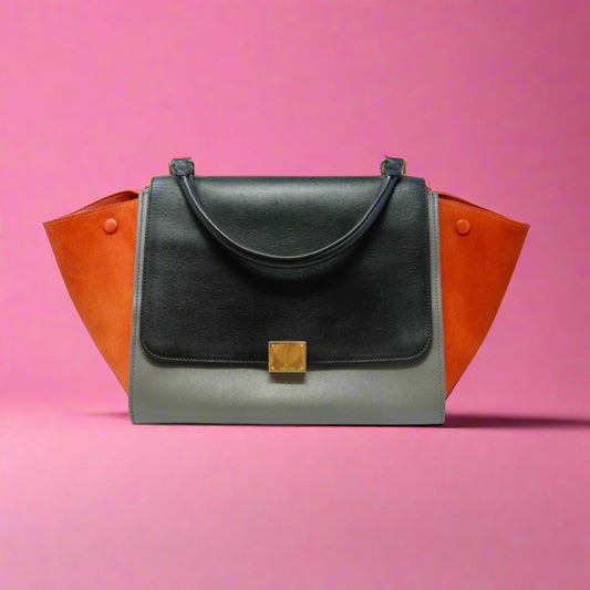 Black handbag with orange accents on a white background