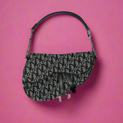 Black patterned handbag on a pink background