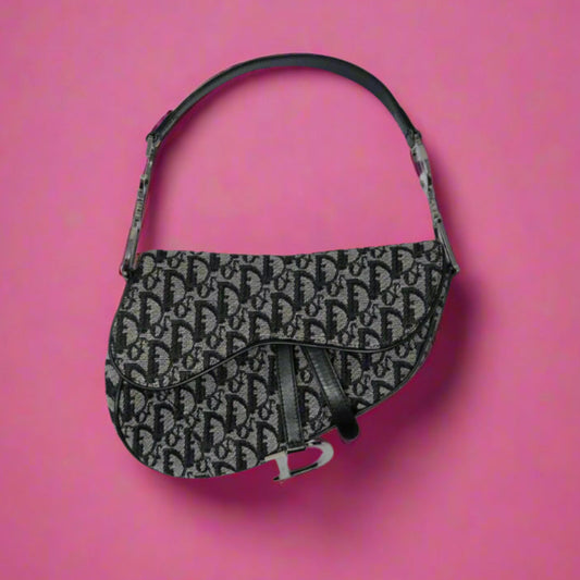 Black patterned handbag on a pink background