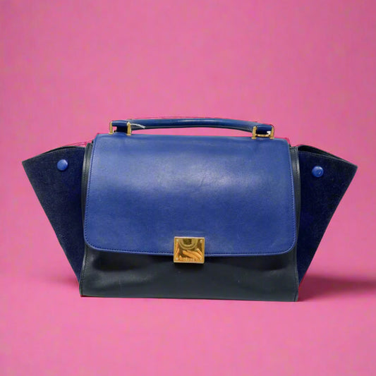 Blue handbag with gold clasp on a white background