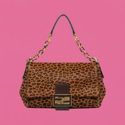 Leopard print handbag with gold accents on a white background