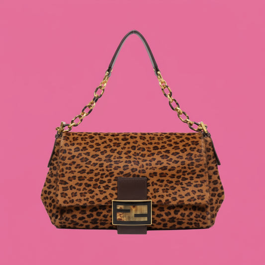 Leopard print handbag with gold accents on a white background
