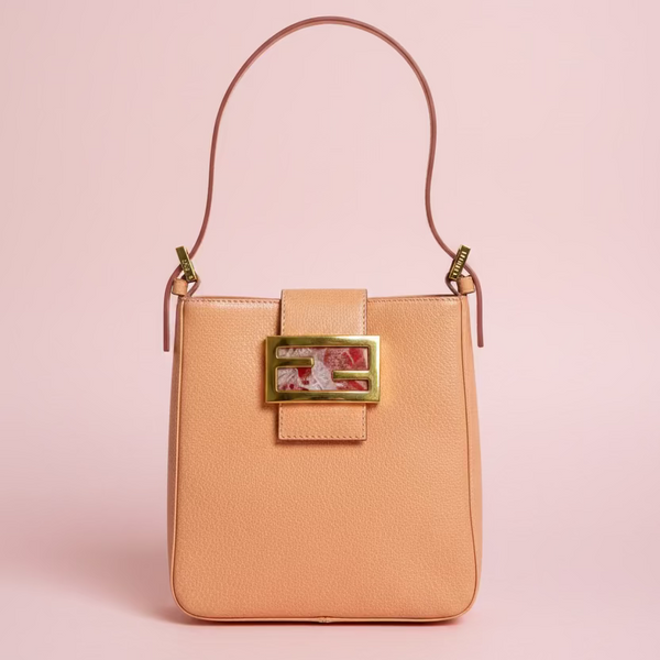 A peach-colored pebbled leather shoulder bag with a gold-tone Fendi FF logo clasp and a matching leather strap, shown on a plain white background.